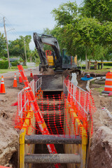 Construction Zone with Safety Measures and Pipeline Installation. Site featuring safety cones,...