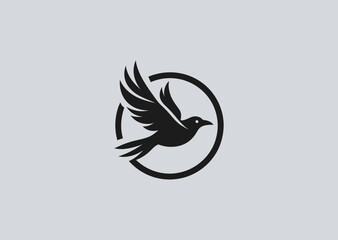 Fototapeta premium Flying crow silhouette logo for mystery, freedom, or dark branding.