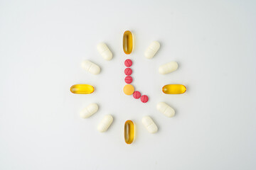 Clock made of pills capsules, pills form a circle, omega, vitamins, Cod liver oil, supplements