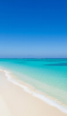 Serene coastal view with calm waves and vibrant blue ocean under clear sky