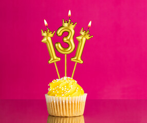 Birthday celebration with number 131 candle - Yellow cupcake on a pink background