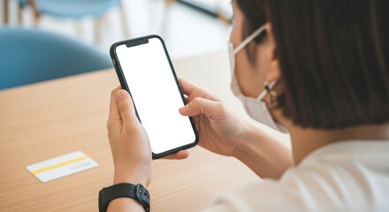 Female hand holding smartphone with a clean, blank screen for digital mockups, ads, or app previews.