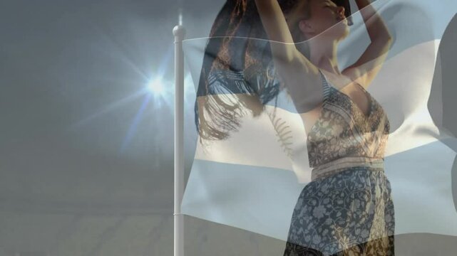 wind rustling dunes and Argentine flag, fashion model lifting fringed scarf for editorial shot