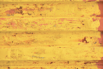 Yellow grunge sea freight container background, rusty corrugated pattern, red primer coating,...