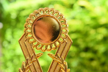 beautiful golden trophy of football contest on green tree background