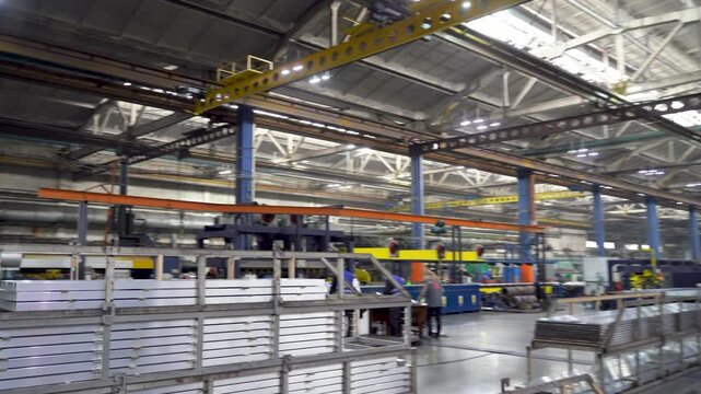 Aluminum Manufacturing Plant Interior With Stacked Metal Profiles and Machinery