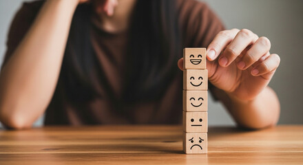 Excellent business service rating and customer experience. Woman choosing a smiley face icon on a wooden cube, reflecting high satisfaction levels.