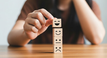 Customer satisfaction survey concept. A woman’s hand selects a smiley face on a wooden block, symbolizing excellent business service and positive customer experience.