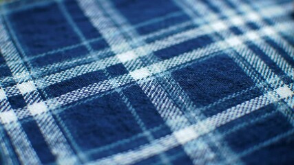 Close-up of a blue and white plaid fabric - Powered by Adobe