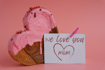 WE LOVE YOU MOM message on paper note greeting card Mother's Day Delicious fresh croissant topped...