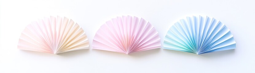 Three pastel-colored paper fans, in shades of pink and blue, with a gradient effect