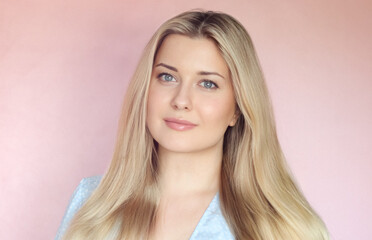 Naklejka premium Glossy hair, glowing complexion, natural beauty and fresh facial skincare. Woman with radiant skin, blue eyes and long blonde hair in a soft studio portrait