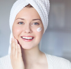 Beauty routine, morning skincare and wellness. A beautiful woman with blue eyes and a white towel...