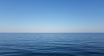 Obraz premium Calm, vast expanse of ocean meets a clear, serene sky.