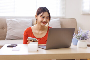 Trouble and problems with money. asian woman using laptop calculator for counting funds pension...