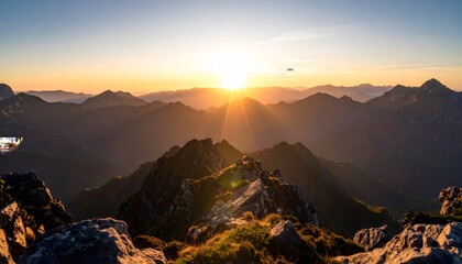 Golden Sunrise Over Jagged Mountain Peaks, Illuminating Rocky Terrain and Distant Ridges