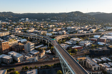 Obraz premium Aerial drone picture of Downtown Portland at sunset, Pearl District, industrial area, residential and office buildings, with clear blue summer sky