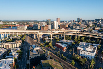 Aerial drone picture of Downtown Portland at sunset, Pearl District, industrial area, residential and office buildings, with clear blue summer sky