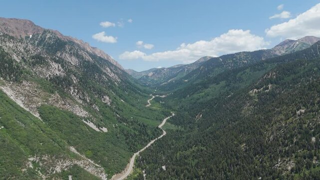Aerial-View of winding road through the rugged granite peaks of Little Cottonwood Canyon, Utah
