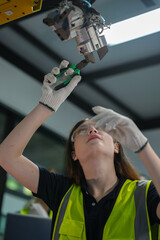 Caucasian engineer woman working on AI technology in robotics electronics engineering laboratory. University students' research project is programming robot machine with intelligent mechanical control