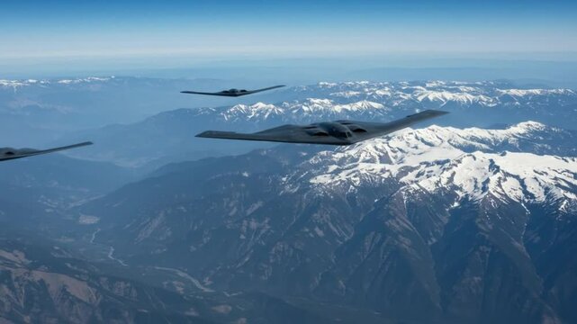 Aerial view of b two spirit bombers flying in formation over snow capped mountains on a clear day