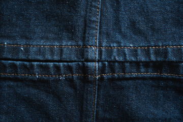 Fototapeta premium The leg opening of blue jeans, with stitching that divides the fabric equally into four sections