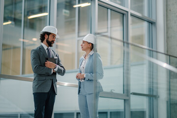 Architects discussing building plans in modern office building