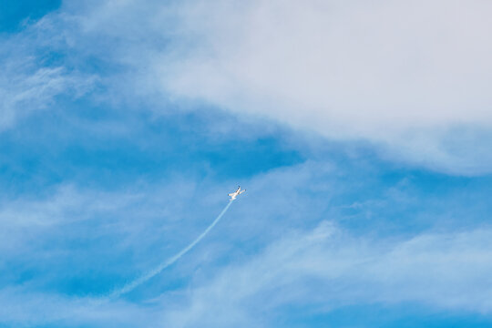 Aerobatic Aircraft Performing Maneuver in Clear Sky