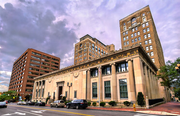 Elegant exterior view of the Wilmington Public Library in Delaware, USA, showcasing its neoclassical architecture with grand columns, detailed stonework, and arched windows in a civic urban setting.