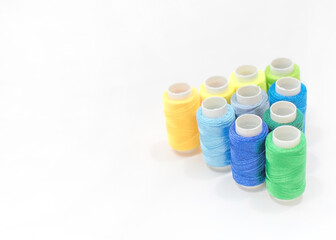 Thread Spools in Triangle Formation with Copy Space on the Left