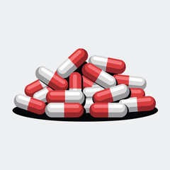 Pile of red and white capsules on a light gray background
