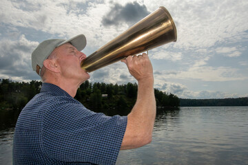 Stockholm, Sweden A man uses a foghorn to scream out a message.
