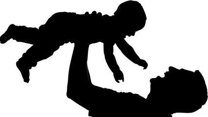 Silhouette of a father lifting his baby in the air while lying on his back in a playful moment together