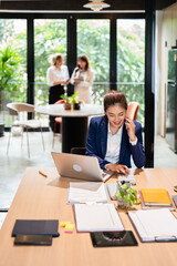 businesswoman working by phone and laptop in modern office .