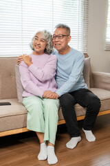 Old senior couple in love hug and embrace with romance together at home . happy mature retired...