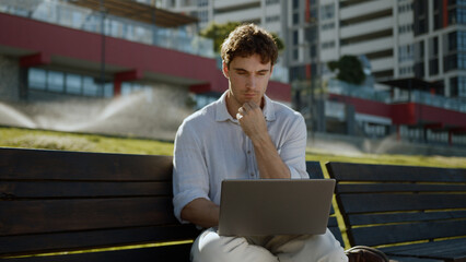 Thoughtful pensive Caucasian man businessman freelancer street outdoor male guy working laptop...