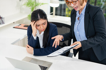 strict boss woman swearing at depressed employee woman for bad work at the workplace looking angry