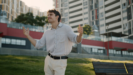 Caucasian young man dancing dancer celebrate enjoyment moving listen music energetic weekend happy...