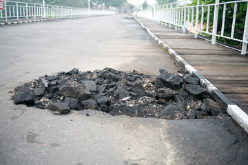 Pile of asphalt rubble on the side road