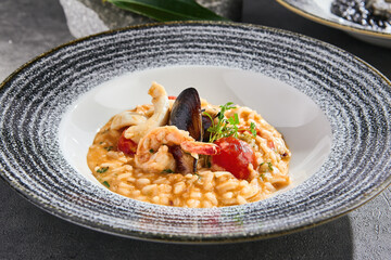Seafood risotto in bright natural lighting, overhead composition with modern ceramic plating