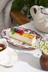 Cheesecake slice with mixed berries, bright natural lighting, overhead composition