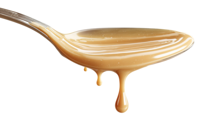 Sweet condensed milk flowing down from spoon into bowl isolated on transparent white background, clipping path
