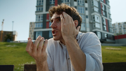 Angry Caucasian man talking mobile phone smartphone shout scream boss director quarrel conflict...