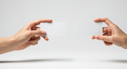 Hands holding blank card horizontally against a clean background, ready for design insertion
