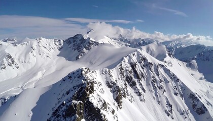 High-altitude aerial view of snow-capped mountain peaks