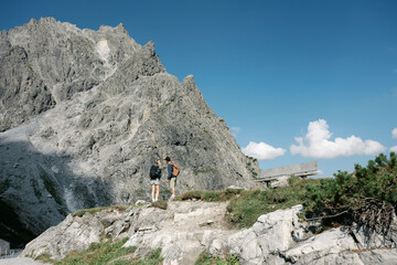 Hikers admiring breathtaking mountain view in the dolomites