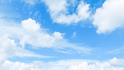 White cumulus cloud formation on blue sky in summer. Blue sky with clouds. Soft white clouds float in the clear blue sky. Clear blue sky, bright spring, wallpaper landscape.