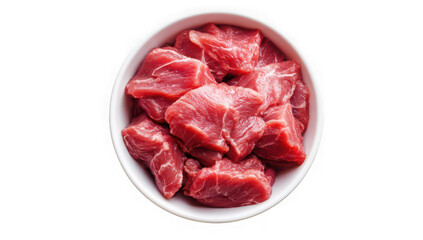Overhead view of diced raw beef chunks piled high in a white bowl against black backdrop