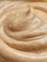 Close up of Creamy Beige Food Texture, Swirled Pattern.