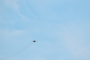 F-16 Military Jet Performing Exhibition Maneuver in the Sky